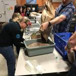 AT&T employees, from left, Kristin Burrows and Roger Jochim donate their time at Hopelink in Kirkland. Contributed photo