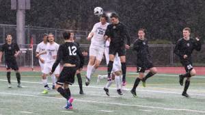 Lake Washington&rsquo;s Edgar Iniguez (third from right) goes up for a header in the rain against Interlake. Courtesy of Doug Lewis