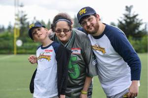 Lindsey and Erik, right, use to be Miracle League kids, but now that they&rsquo;re grown up they come as helpers with the younger kids such as Liam, left. Contributed photo/Chris Rusnak