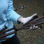 Merrily Dicks holds a sample of &ldquo;The Spikes&rdquo; sculpture that is displayed in her Kirkland backyard. One of her assistants, Yancy McCoy, helped create this piece. The full sculpture has been installed on the Cross Kirkland Corridor. CATHERINE KRUMMEY / Kirkland Reporter