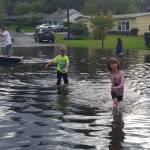 Local residents check out the water buildup near the intersection of 145th Street and 75th Avenue at the Kirkland-Kenmore boundary. Contributed photo