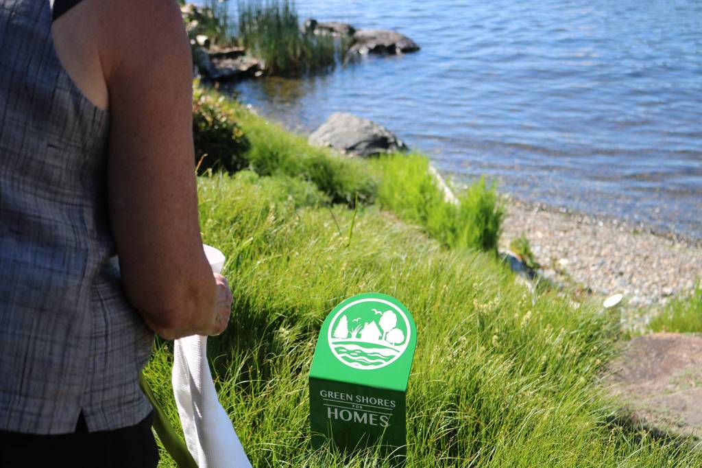 Pam Bendich unveils the Green Shores for Homes plaque on her property in Kirkland. CATHERINE KRUMMEY / Kirkland Reporter