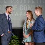 Olympic gold medalist Michael Phelps (left) talks with Patricia Bell (center) of Kirkland and Tyler Fiorino of Spokane after they were honored for their volunteer work. Courtesy photo