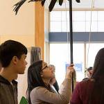Impending Loom team member Laura Chen holds a condor prop at a recent competition as her twin brother and teammate, Adam Chen (left), observes. They are both juniors at Juanita High School. Courtesy photo