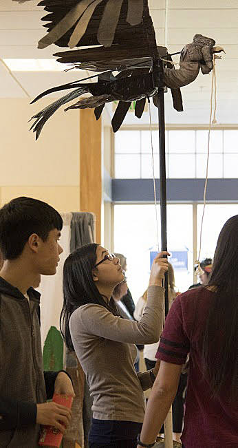 Impending Loom team member Laura Chen holds a condor prop at a recent competition as her twin brother and teammate, Adam Chen (left), observes. They are both juniors at Juanita High School. Courtesy photo