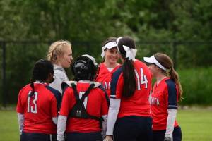 Juanita&rsquo;s softball players gather during a game earlier this week. Courtesy of Gayle Richardson