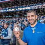 Flo Groberg, Boeing&rsquo;s director of veterans outreach and Medal of Honor recipient, prepares to throw out the ceremonial first pitch at the Mariners Salute to Armed Forces game, sponsored by Boeing.