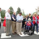 Kirkland City Councilmember Doreen Marchione (center, with the big scissors) cuts the ribbon at the new parking lot in downtown Kirkland alongside fellow councilmembers, city staff and representatives of the Kirkland Downtown Association and Greater Kirkland Chamber of Commerce. Photos courtesy of the City of Kirkland