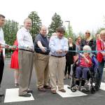 Kirkland City Councilmember Doreen Marchione (center, with the big scissors) cuts the ribbon at the new parking lot in downtown Kirkland alongside fellow councilmembers, city staff and representatives of the Kirkland Downtown Association and Greater Kirkland Chamber of Commerce. Photos courtesy of the City of Kirkland