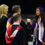 Graduating senior Elizabeth Bensussen fist bumps with Lake Washington High School&rsquo;s associate principal Brian Story during the commencement ceremony at Key Arena. Courtesy of Lake Washington School District