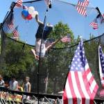 A Kirkland youngster does a backflip inside a trampoline that was set up for a previous Fourth of July parade in downtown Kirkland. Reporter file photo