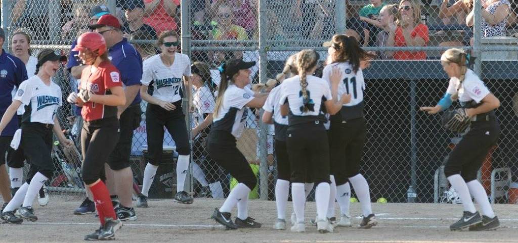 Kirkland players surround center fielder Amy Chen after she threw out a Canadian runner to cap off her team&rsquo;s 3-2 win. Courtesy of Eric Chen