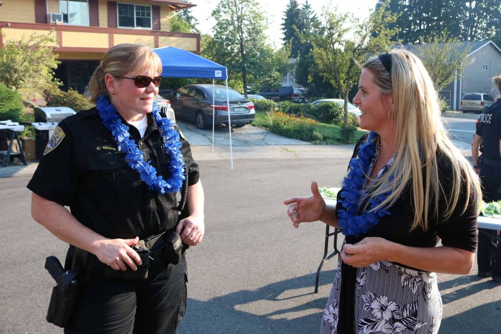 Kirkland Police Chief Cherie Harris speaks to Cameron Hanson during a community barbecue in the 13600 block of 116th Avenue Northeast during National Night Out Tuesday. Megan Campbell/staff photo