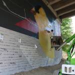 Jake &ldquo;DKoy&rdquo; Wagoner works on the mural Monday. The mural Wagoner is creating is titled &ldquo;What is…&rdquo; and prompts the community to answer questions such as, &ldquo;What is life?&rdquo; or &ldquo;What is love?&rdquo; Megan Campbell/staff photos