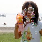 Tia Ekle, 4, plays with her bubble gun during Kirkland&rsquo;s Summerfest Aug. 11. Megan Campbell/staff photo