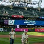 Bill Savoy (left) watches on as MaryAnn Orrison, his former foster mother, throws a first pitch at a recent Seattle Mariners game. Courtesy photo