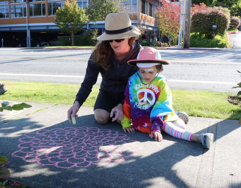 Megan Nandi and her daughter Caroline draw a flower on sidewalk in front of Google. Samantha Pak, Kirkland Reporter