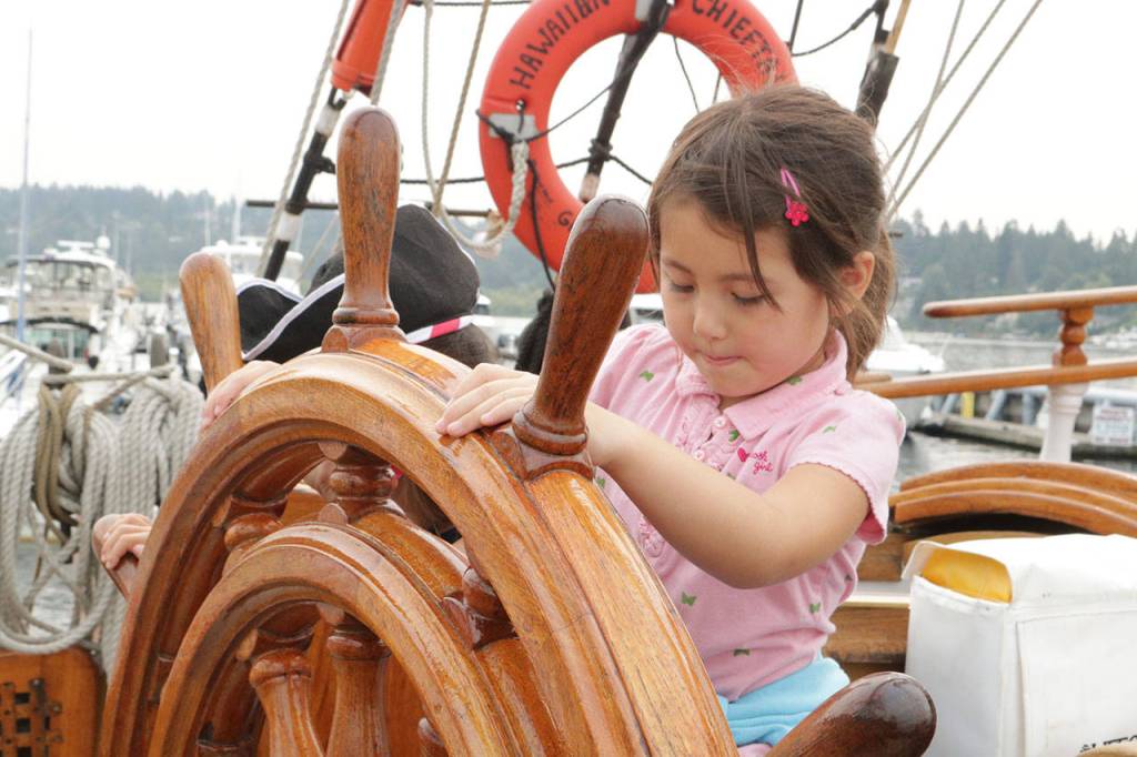 Mira Vinyar, 4, takes her turn at the helm on the Hawaiian Chieftain Sept. 7. Megan Campbell/Kirkland Reporter