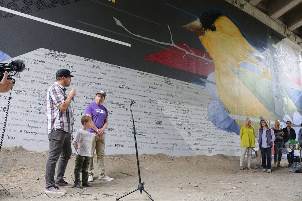 Artist Jake &ldquo;DKoy&rdquo; Wagoner, his son Dylan, 4 1/2, and Mike Lucero speak about the mural during the Crossing Kirkland celebration Saturday. Megan Campbell/Kirkland Reporter