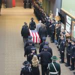 A procession for Sgt. Nathan Rich with family members and officers from the Kirkland Police Department makes it way down the hall of the Overlake Christian Church in Redmond. Samantha Pak, Kirkland Reporter