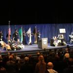 The color guard and the audience stands at attention for the national anthem, performed by Capt. Keith Sessions of South Snohomish County Fire and Rescue RFA, at Sgt. Nathan Rich&rsquo;s memorial service. Samantha Pak, Kirkland Reporter