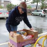 A volunteer loads food boxes onto a cart. Samantha Pak, Kirkland Reporter