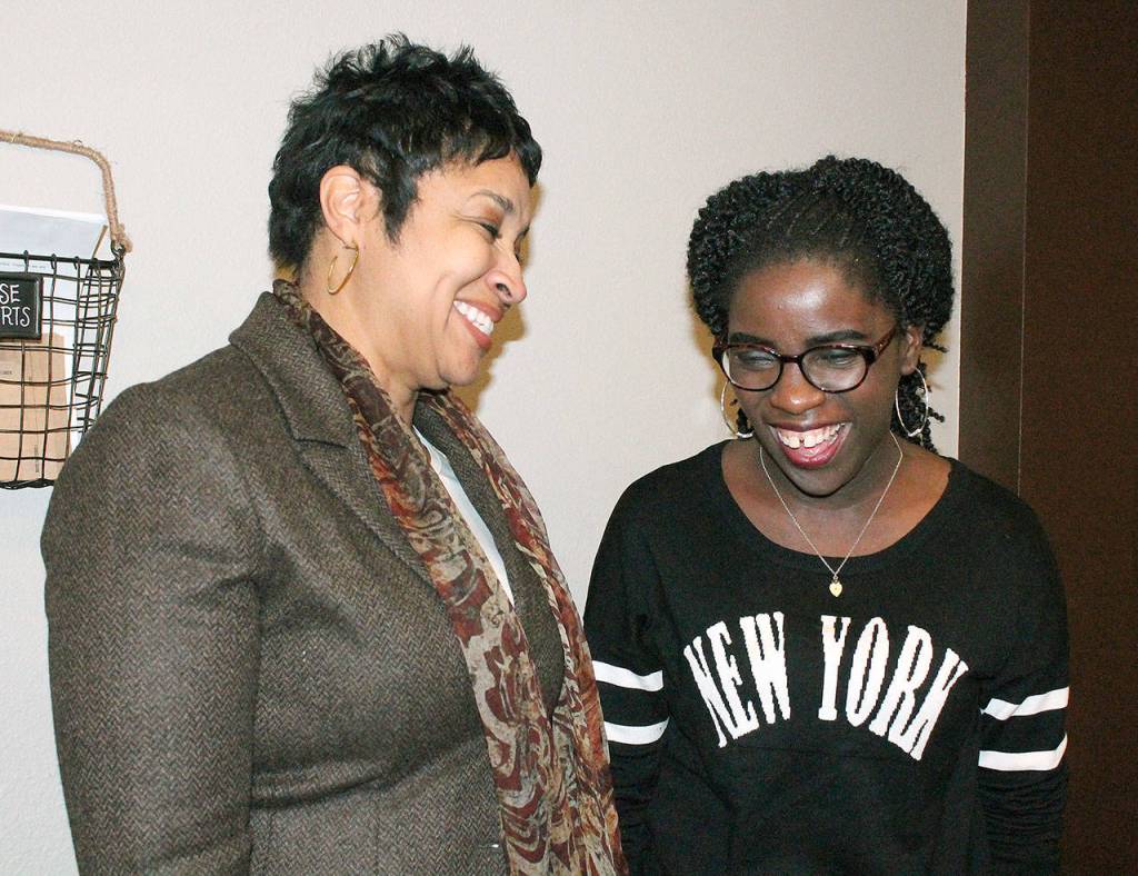 Federal Way Public Schools Superintendent Dr. Tammy Campbell, left, and Phiona Mutesi, a young Ugandan woman who gained international acclaim as a chess champion, share a laugh before a Chess with the Superintendent event at Family Life Community Church Wednesday. Jessica Keller, Sound Publishing