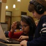 Two first graders at Robert Frost Elementary School work on a game during Hour of Code. Kailan Manandic, Kirkland Reporter