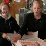 Kristine Ott alongside her daughter, Kalie, boxes the final cake sold at the Bridle Trails Dairy Queen. Kailan Manandic, Kirkland Reporter