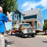 House moving company Nickel Bros. transports the Trueblood House to its permanent location in the 100 block of Sixth Avenue. Megan Campbell, Sound Publishing
