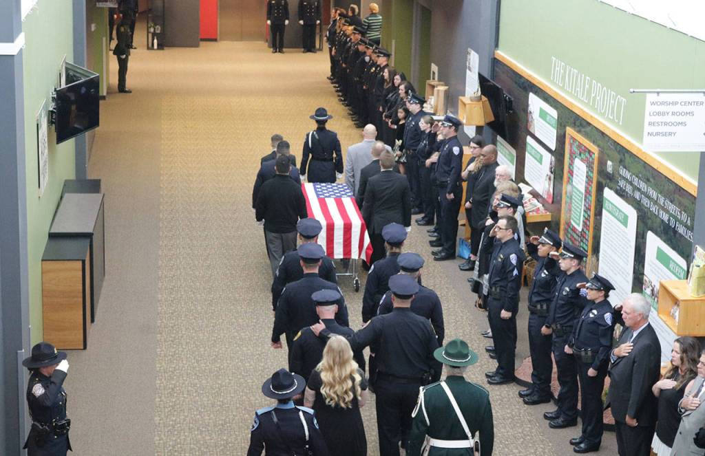 A procession for Sgt. Nathan Rich with family members and officers from the Kirkland Police Department makes it way down the hall of the Overlake Christian Church in Redmond. Samantha Pak, Kirkland Reporter                                A procession for Sgt. Nathan Rich with family members and officers from the Kirkland Police Department makes it way down the hall of the Overlake Christian Church in Redmond. Samantha Pak, Kirkland Reporter