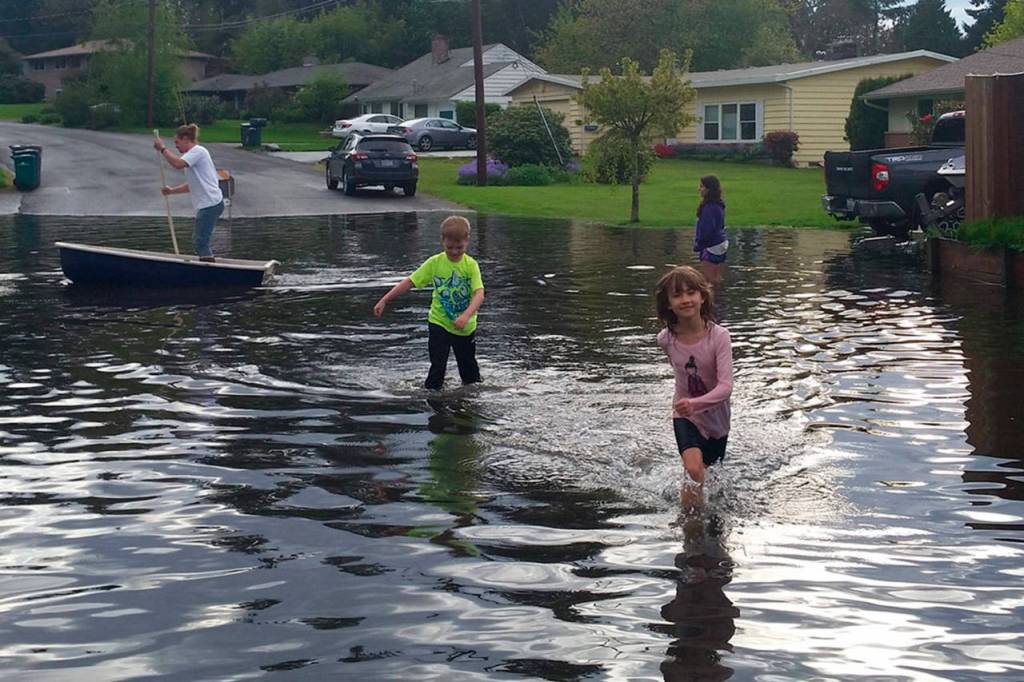 Local residents check out the water buildup near the intersection of 145th Street and 75th Avenue at the Kirkland-Kenmore boundary. Courtesy photo