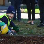 Two-year-old Lorne Muller plays with a toy truck he received from Waste Management drivers Matthew Martinez and Michael Moss on March 15. Kailan Manandic, staff photo
