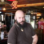 Chris Rohr stands behind the bar at Flood Valley Brewing. Rohr opened the brewery in recent years and hopes to help revitalize the local economy by becoming an anchor business in downtown Chehalis. Aaron Kunkler/Staff Photo