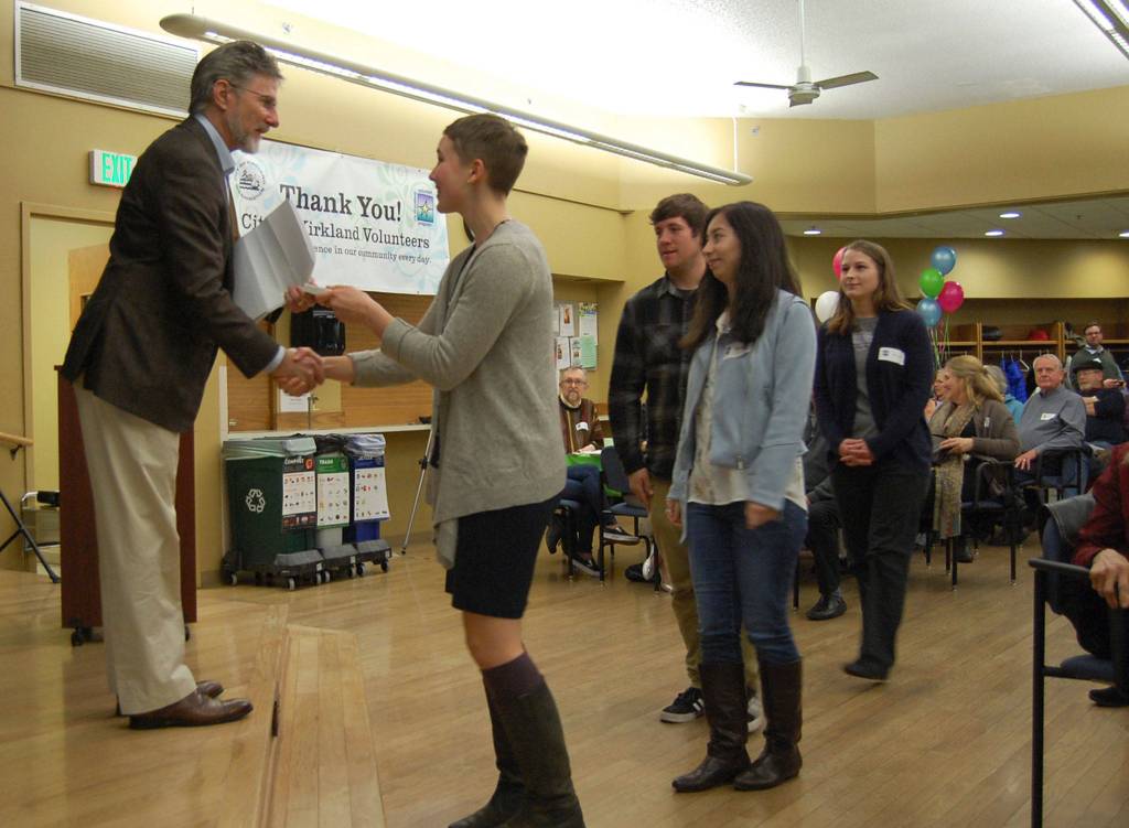 Kirkland City Council member Tom Neir hands out awards to the students on the University of Washington Restoration Ecology Network Team who restored one-third of an acre in North Rose Hill Woodlands Park. Katie Metzger/staff photo