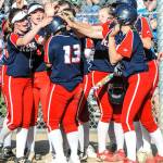 Juanita players congratulate Sasha Mitchell after she slammed one of her two homers against Sammamish on April 25. Photo courtesy of Clifford H. Crawford, CC Photography