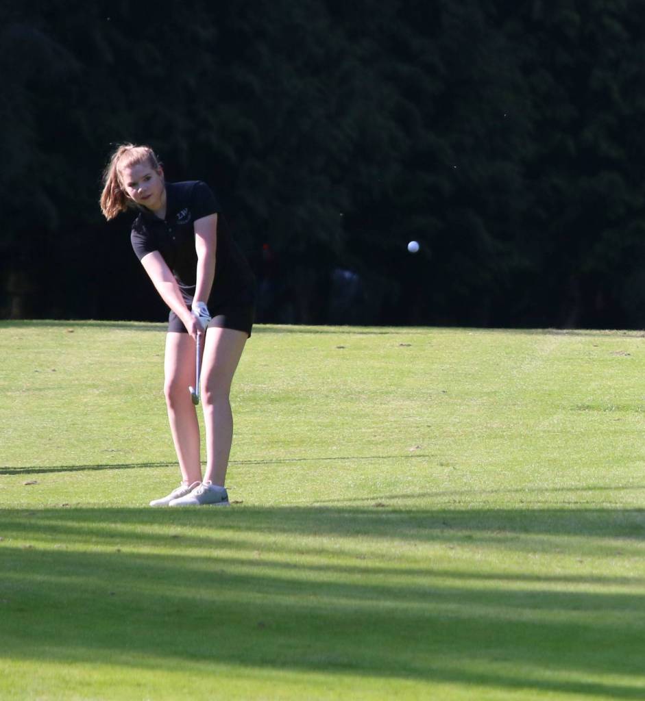 Lake Washingtons Grace Hawkins hits an approach shot on the ninth hole on April 26. Andy Nystrom / staff photo