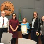 Kirkland City Council member Toby Nixon and Mayor Amy Walen present a proclamation for Affordable Housing Week to Cassandra Sage, Amber Gmerek and Joy Horbochuk on May 1. Photo via Twitter