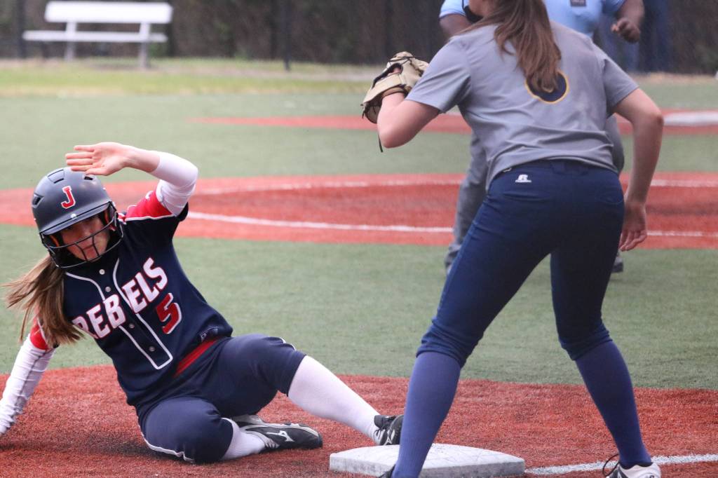 Juanitas Jordan Schroeder slides into third following her two-RBI triple. Andy Nystrom / staff photo