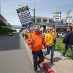 Nurse Katy Roth and her husband, Rod, a union member with Labor Local 292, walk with other nurses on a picket line at Providence Regional Medical Center Everett on Wednesday. (Andy Bronson / The Herald)