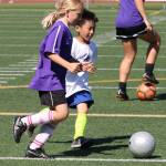 Bottom photo, Campers Marloes Adriaanse, left, and Benjamin Chen practice their dribbling and defensive skills. Andy Nystrom / staff photo