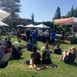 People crowd around the QFC stage as the two local chefs prepare their dishes in the cook-off. Courtesy photo.