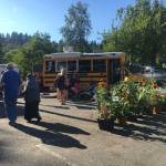 Market goers walk by a farm stand and the Panda Dimsum food truck. Katie Metzger/staff photo