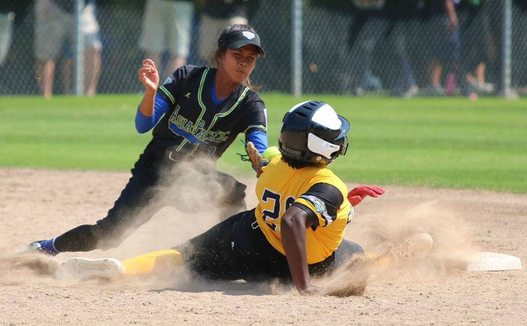 A shortstop from Bacolod City, Philippines tags out a runner from Tampa, Florida. Andy Nystrom / staff photo