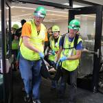 CERT members carry a survivor of a major earthquake to the medical area during a disaster drill in Kirkland City Hall Saturday. Megan Campbell/Kirkland Reporter