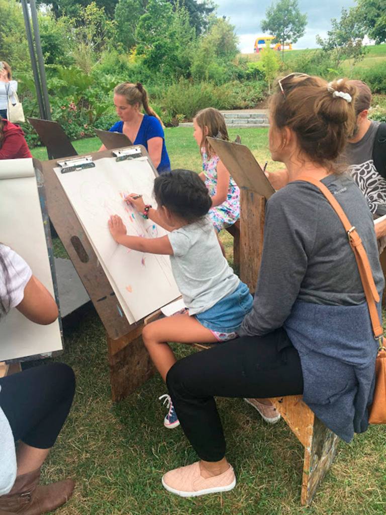 Families learn to draw at Summerfest, Kirklands annual music and arts festival. Katie Metzger/staff photo