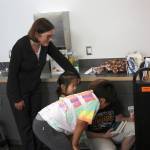 Rep. Suzan DelBene helps local kids pick out one of their free books that they receive along with a free lunch through the Kingsgate Library Summer Meals program. Kailan Manandic/staff Photo