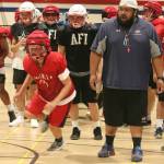 Players run drills around head coach Lele Teo. Andy Nystrom / staff photo
