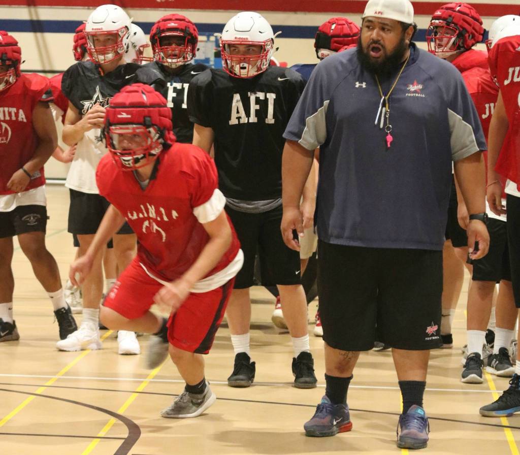 Players run drills around head coach Lele Teo. Andy Nystrom / staff photo