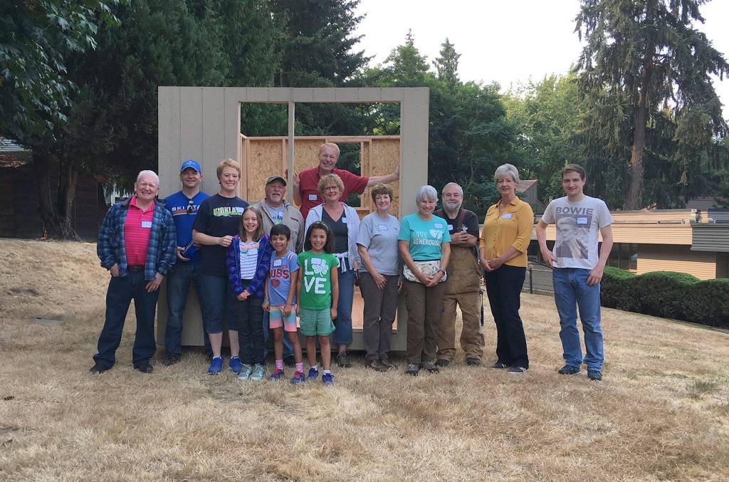 Cal Pygott (in back) smiles with some volunteers who helped him build a tiny home to house a homeless person. Photo courtesy of Holy Spirit Lutheran Church